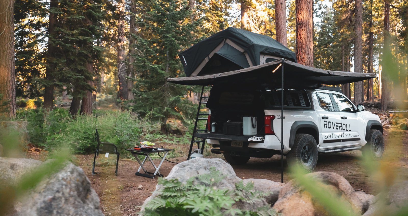Roveroll Tacoma overlanding campsite with canopy camper and roof top tent