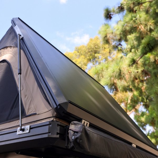 Angled side view of hard shell lid opened on ROVEROLL Aluminum Side Opening Hard Roof Top Tent