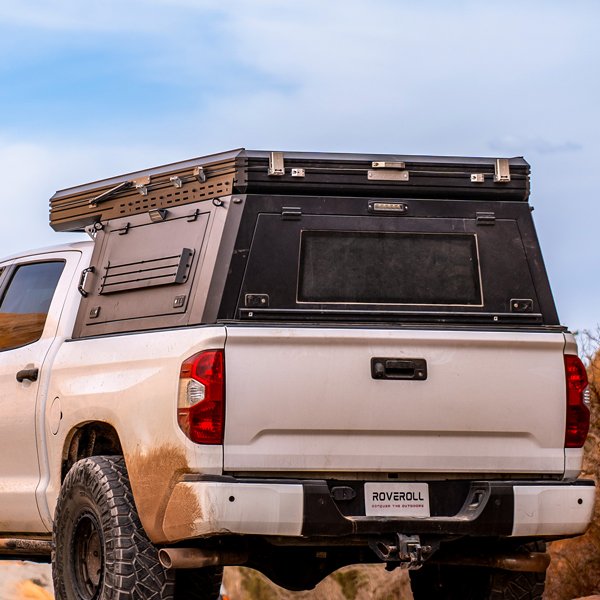 Left rear angled outdoor view of closed ROVEROLL SkyNest Tent Combo mounted on vehicle