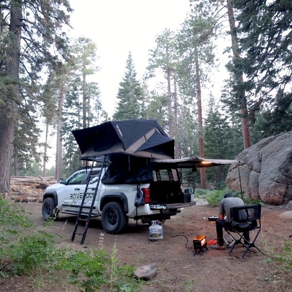 ROVEROLL Soft Shell Roof Top Tent opened on vehicle while camping in the forest