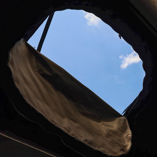 Sky view through sunroof of ROVEROLL Aluminum Side Opening Hard Roof Top Tent