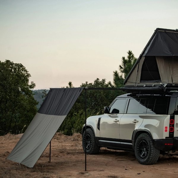 Outdoor side view of ROVEROLL Side Awning mounted on vehicle